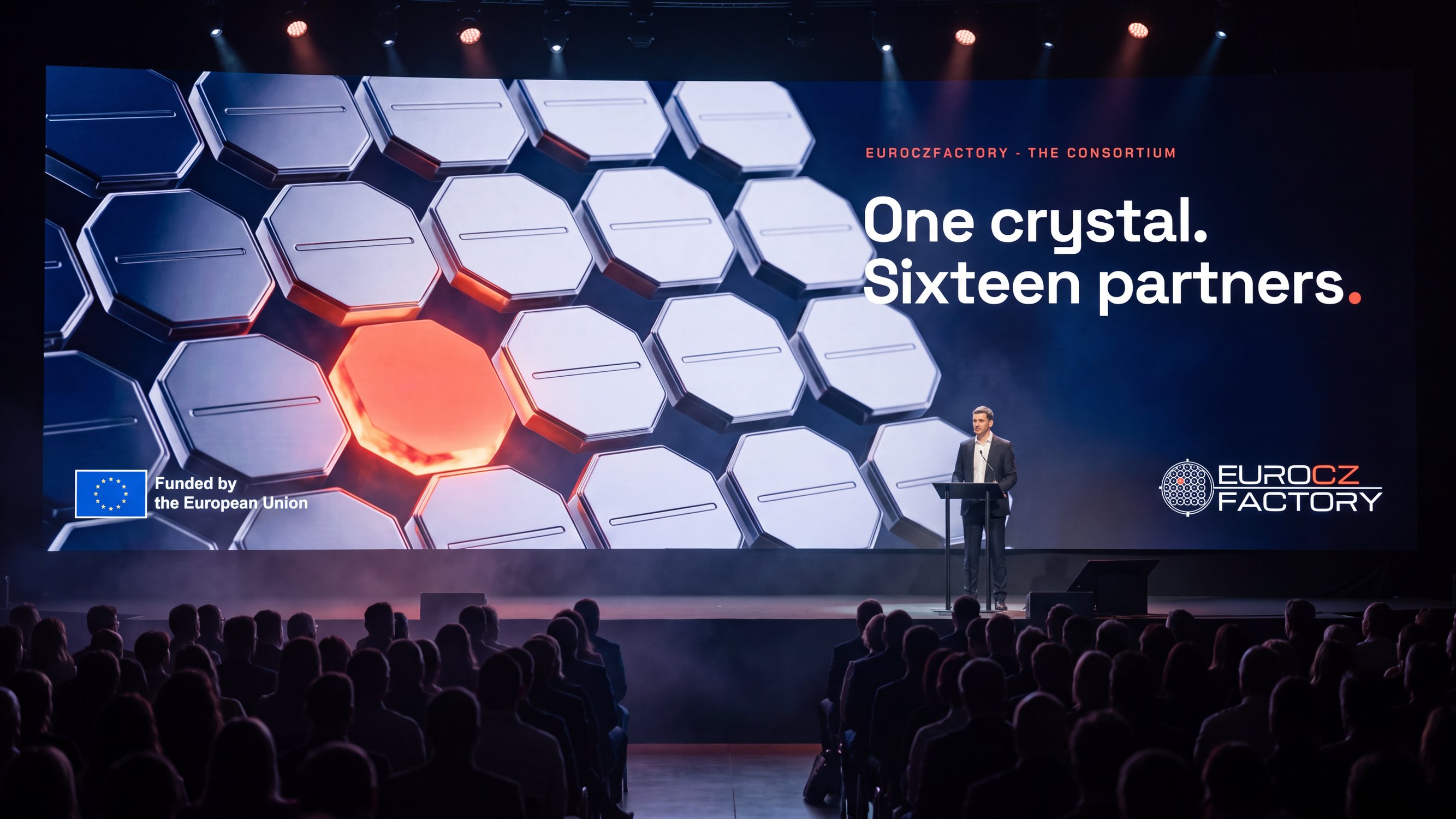 A conference stage, the screen reading One crystal. Sixteen partners.
